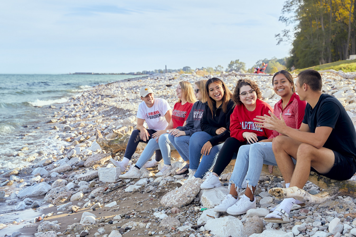 Friends gather at the lakefront to enjoy a summer day on campus.