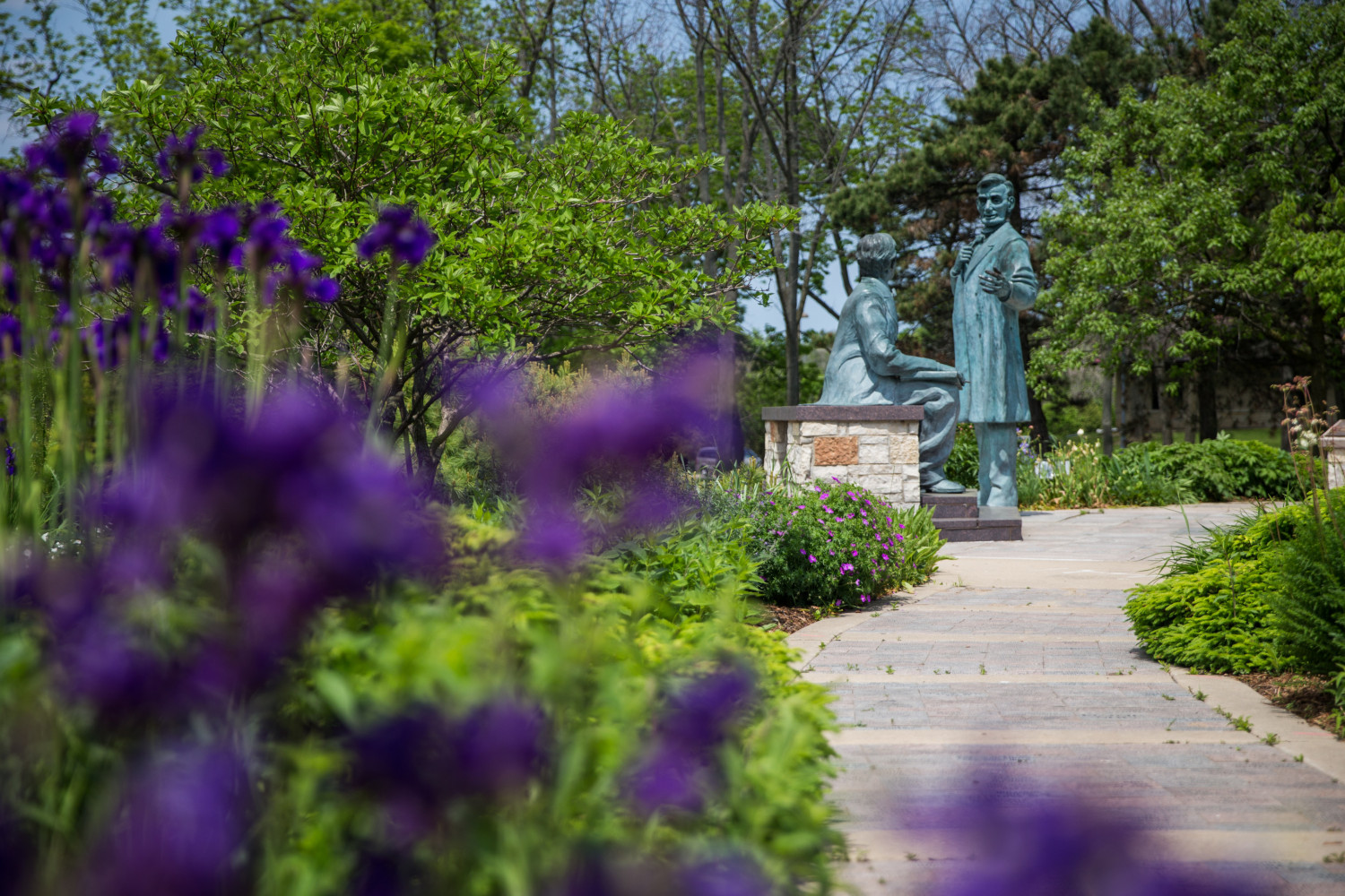 A spring look at the Learning Moment statue on Campus Drive.