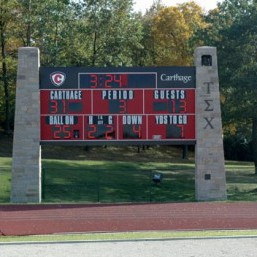 Old Main Bell is seen in the scoreboard at Art Keller Field.