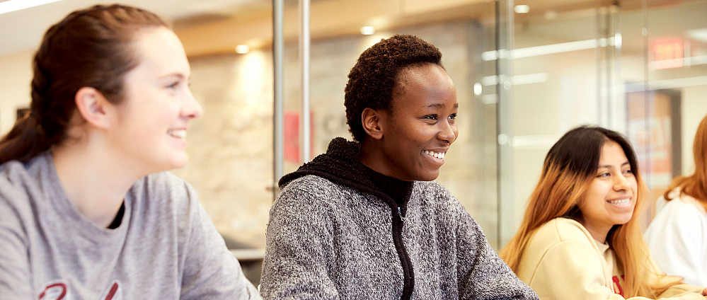 A diverse group of students sitting in a classroom.