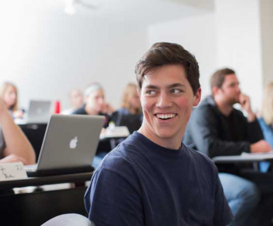 Student sitting in a lecture classroom.