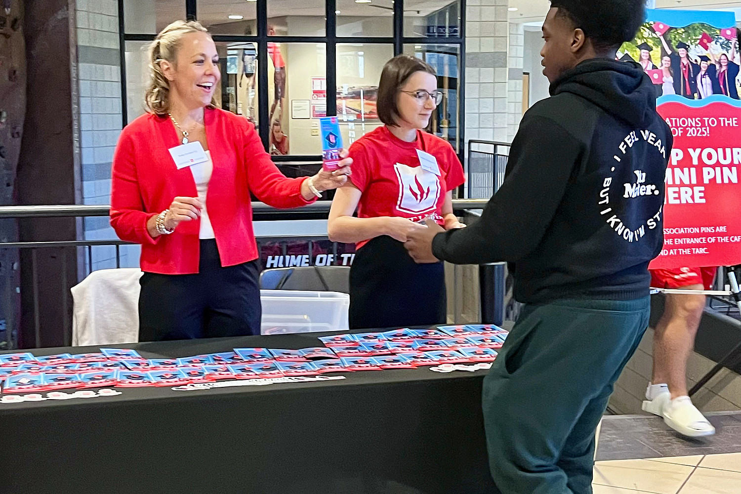 Kate Current '01 and Heather Sockness '18 helping students at a Carthage event
