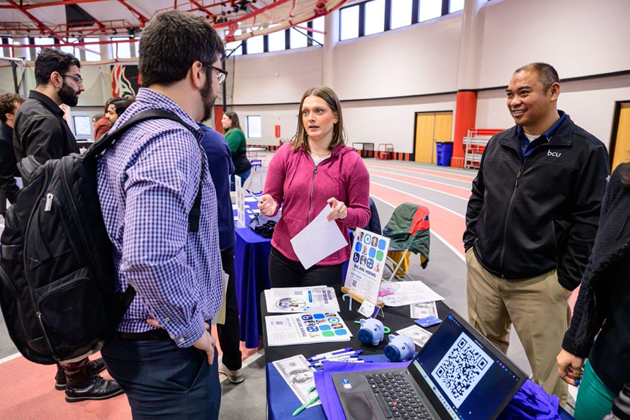 Students talking to employers at a career fair.