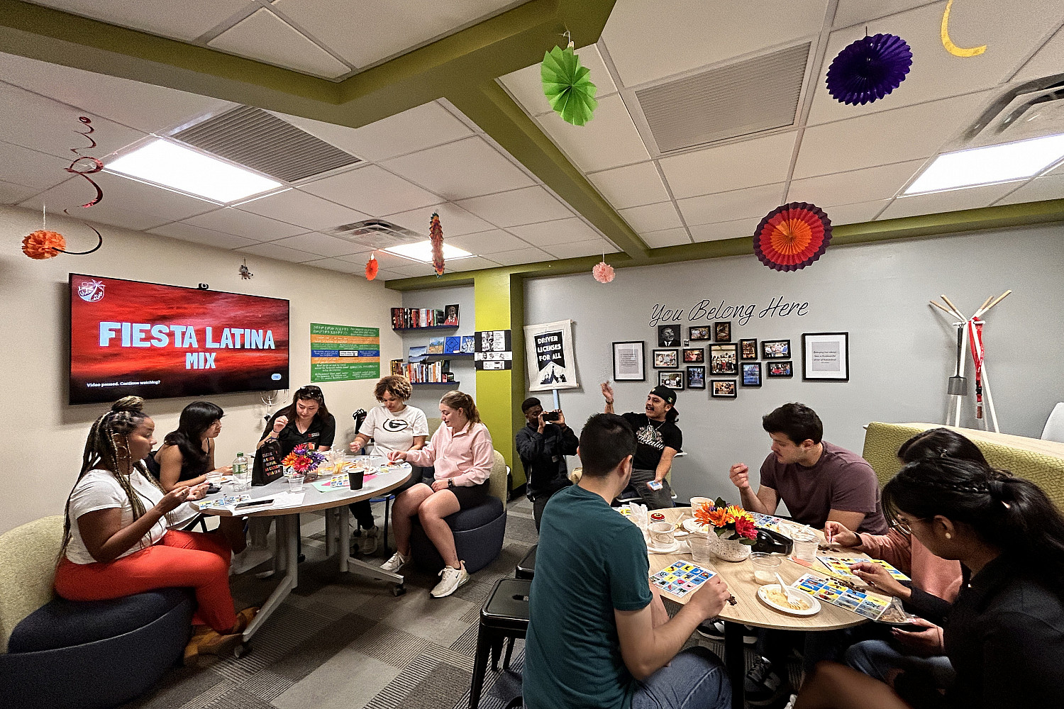 Students sitting at round tables playing games.