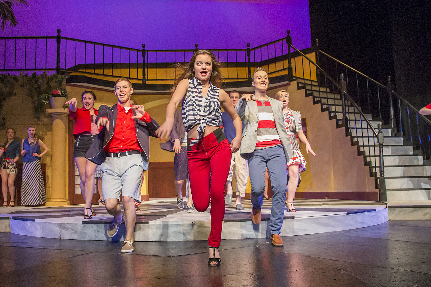 A group of students dancing on a stage.
