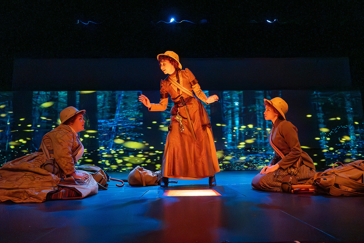 Three women performing a play on stage.