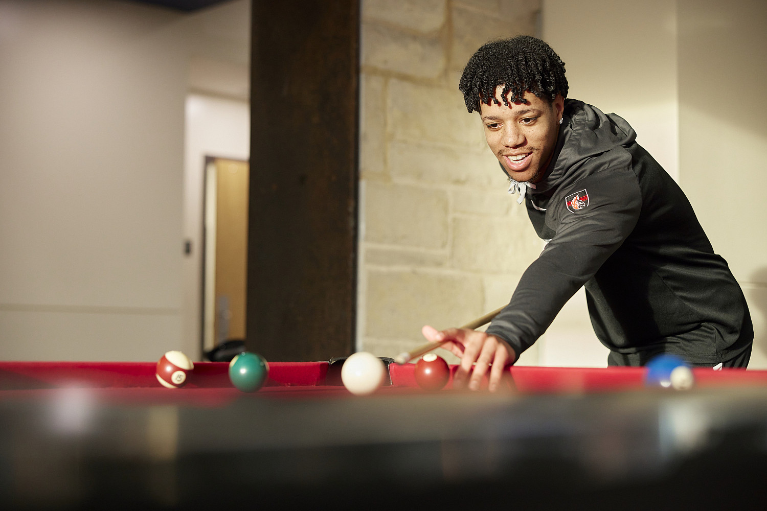 Carthage students play pool and foosball in the Campbell Student Union.