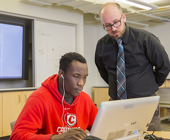 Prof. Daniel Steiner assists a student during class.