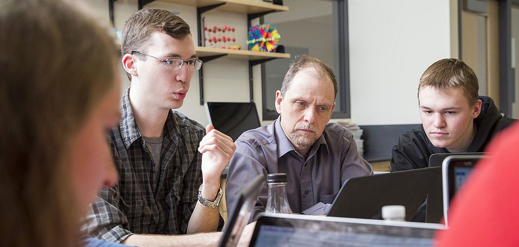 Faculty member working with students.