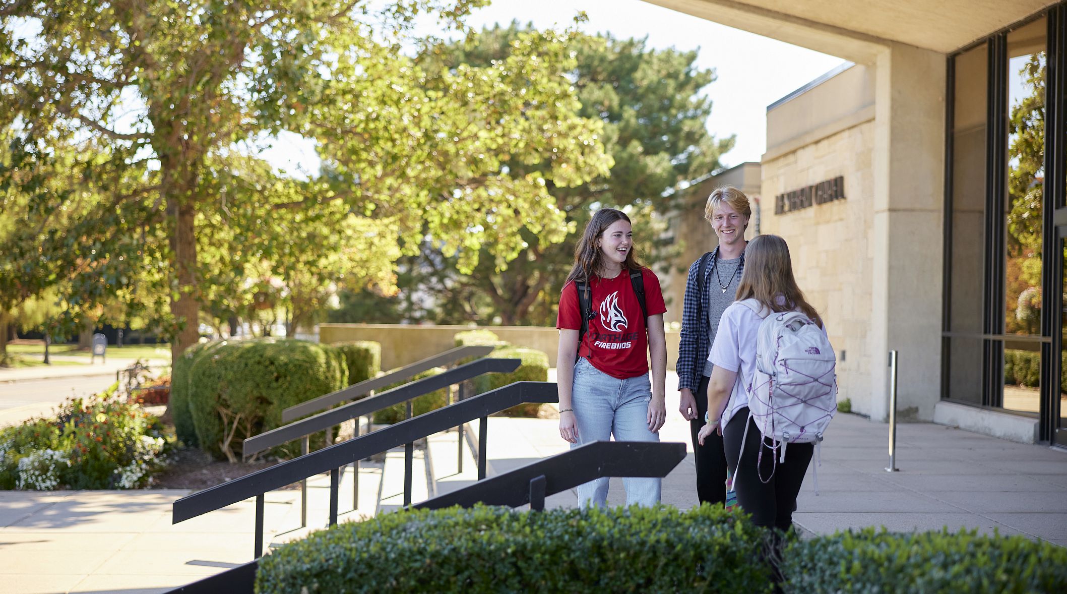 A group of Carthage students standing in front of the A. F. Siebert Chapel.
