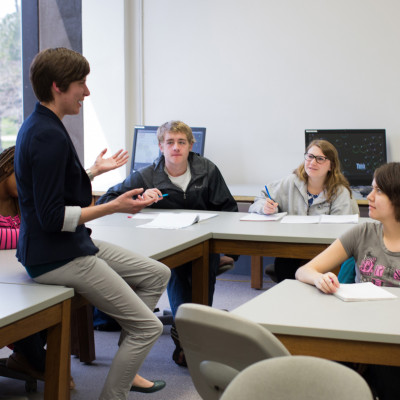 Prof. Haley Yaple helps students in a math class.