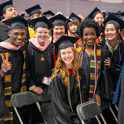 A group of newly graduated Carthage students smile for the camera.
