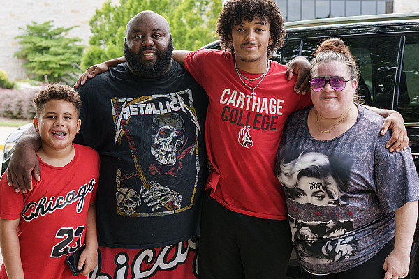 A new Carthage football player and family pose during move-in.